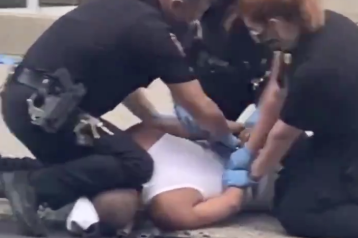 A screenshot from a cellphone video appears to show a police officer pressing his knee into a man's neck, in Allentown, Pa.