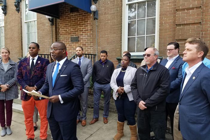 Antwan Lang of the Savannah Jaycees (center), along with leaders of National Action Network, the Young Democrats and Republicans and other groups, calls for the Savannah-Chatham Metropolitan Police Department to remain merged.