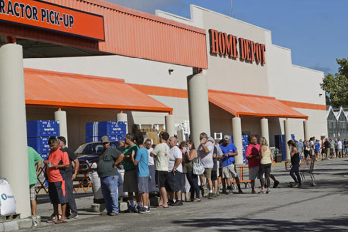 People line up outside a Home Depot for a new supply of generators and plywood in advance of Hurricane Florence in Wilmington, N.C., on Sept. 12, 2018.