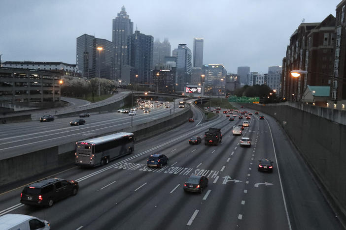 Lighter than normal early morning traffic moves in and out of downtown Atlanta Monday, March 16, 2020. Many schools are closed and more people are working remotely due to concerns over the spread of the coronavirus. 