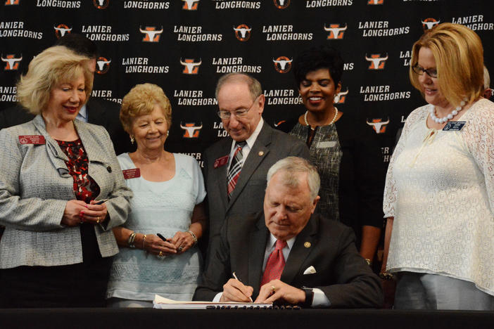 Governor Deal signed the fiscal year 2017 budget at Lanier High School in Buford, Georgia surrounded by state lawmakers.