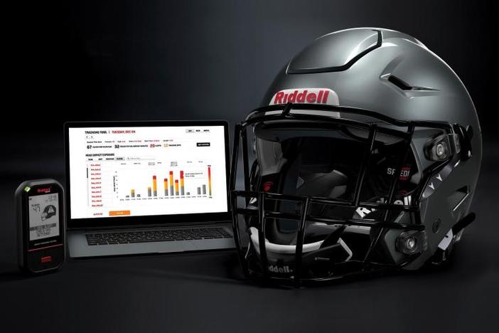 In this May 2020 photo provided by Riddell, a Riddell SpeedFlex helmet sits next to a computer screen displaying information from the InSite tool. 