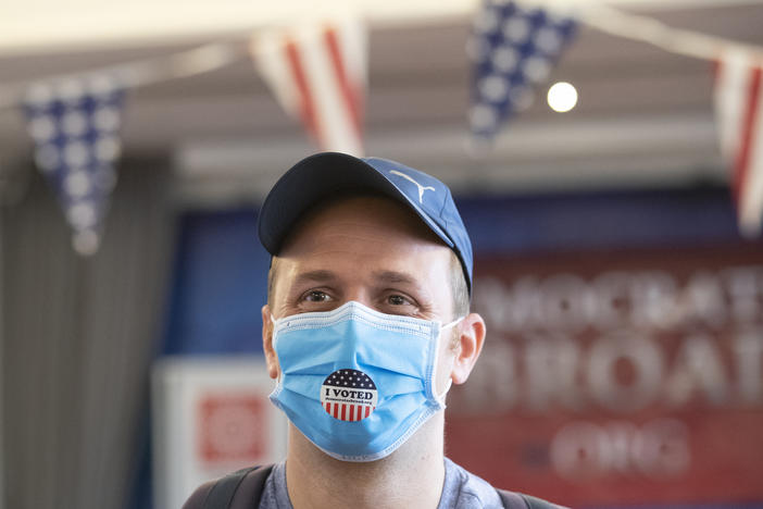 Elliott Zaagman from Michigan put wears his mask after casting vote on the Super Tuesday, for U.S. Democrats Abroad multi-location global primary at Foreign Correspondents' Club of Thailand, Tuesday, March 3, 2020.