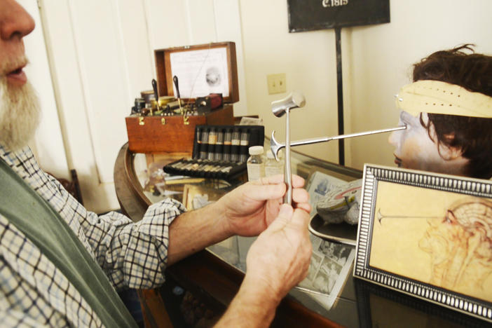 Edwin Atkins demonstrates the use of lobotomy instruments with tools in his personal collection of Central State Hospital artifacts. 