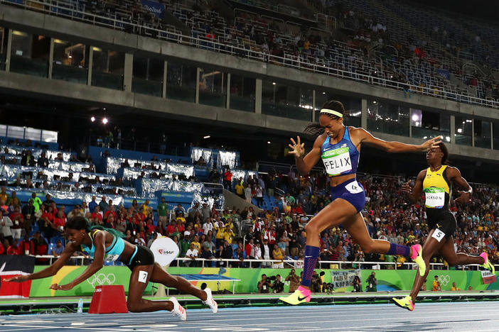Shaunae Miller of the Bahamas (left) dives over the finish line to win the gold medal in front of Allyson Felix of the U.S., in the women's 400-meter race. Felix won silver; Shericka Jackson of Jamaica (right) won bronze.