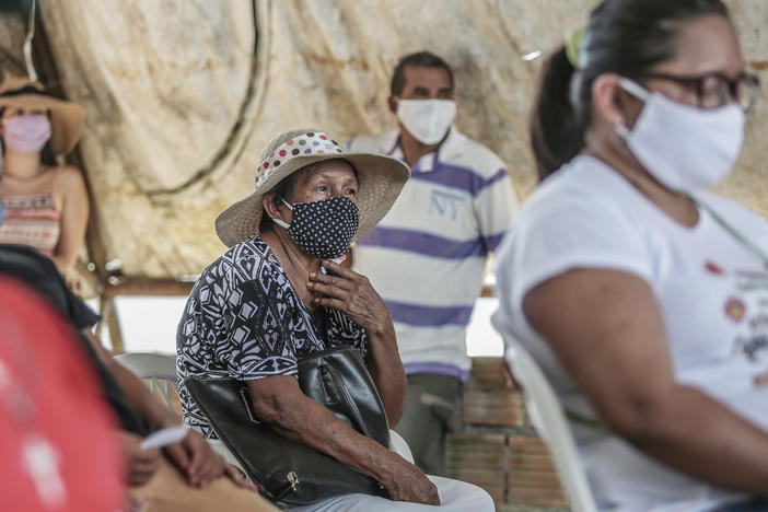 People wait for a flu vaccine in May in Manaus, Brazil. The flu season had a surprisingly low count of influenza cases in the Southern Hemisphere, and researchers are trying to figure out the role coronavirus precautions might have played.