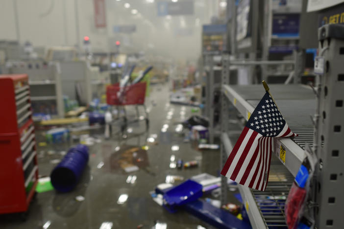 A flag drapes across looted shelves in a hardware store during widespread unrest following the death of George Floyd on May 31, 2020 in Philadelphia, Penn.