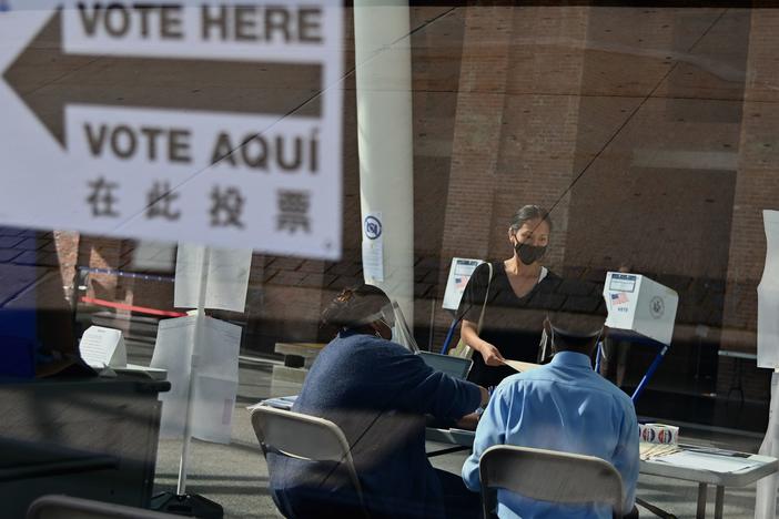 Many people who normally take on jobs as poll workers are in higher-risk groups for the coronavirus, leading to fears of a widespread shortage of poll workers. Here, New York City Board of Election employees and volunteers help voters at the Brooklyn Museum polling site during the New York Democratic presidential primary in June.