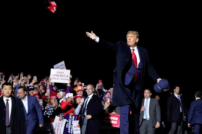 President Donald Trump throws hats to supporters after speaking Wednesday at a campaign rally at Duluth International Airport in Minnesota.