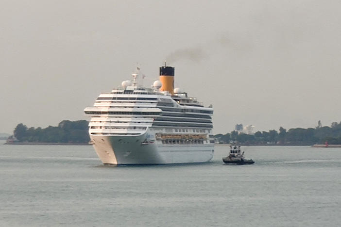 A cruise ship is shown here approaching a port in Singapore in March. Singapore plans to launch cruises with no destinations next month.