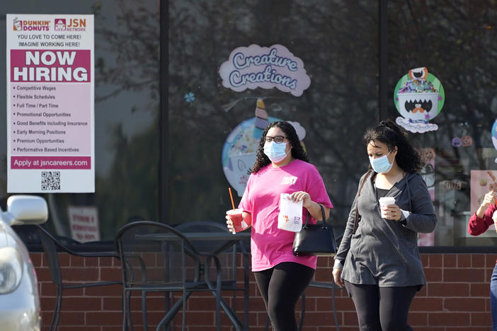 People wear face masks as they leave a store in Vernon Hills, Ill., last week. State health officials say the number of coronavirus cases and COVID-19 deaths in the state are hitting worrisome new highs.