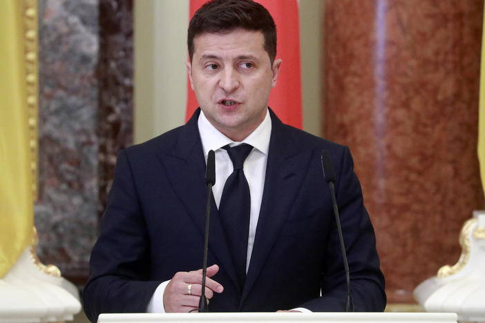 Ukrainian President Volodymyr Zelenskiy speaks during a joint news briefing with Polish President Andrzej Duda in Kyiv, last month. A spokeswoman for Zelenskiy says that he has been hospitalized for COVID-19.