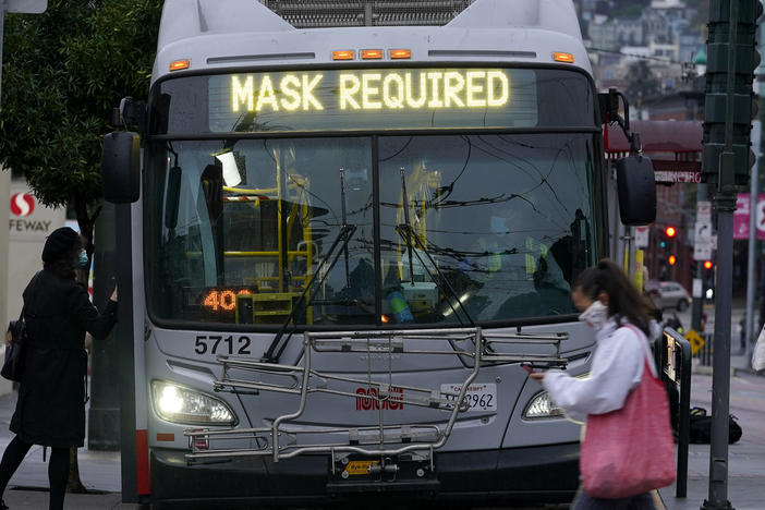 A sign on a San Francisco bus advises that passengers are required to wear masks. Health officials have renewed pleas for Americans to protect themselves and others from the coronavirus as the death toll passes 250,000.
