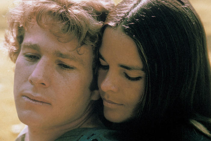 Ryan O'Neal and Ali MacGraw starred in <em>Love Story</em> — a romantic tearjerker that became the highest grossing movie of 1970. Since then, it has inspired countless ugly cries — and plenty of parodies, too.