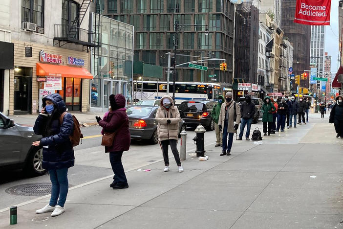 A line forms outside a COVID-19 testing clinic in Lower Manhattan. Long waits have created a business opportunity for line standers who used to queue up for others at Broadway shows and other major events.