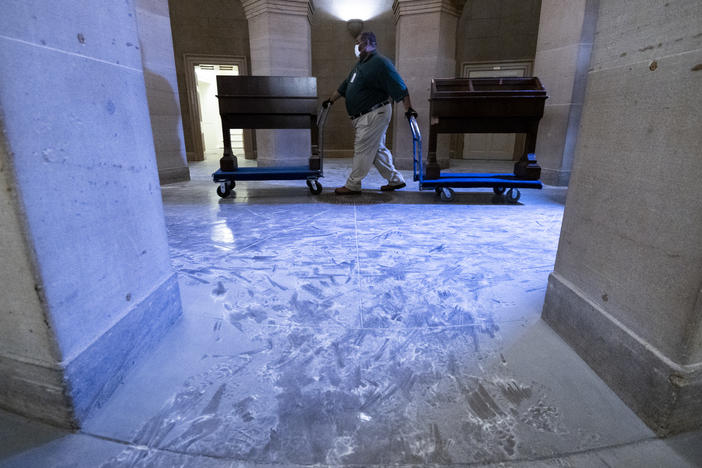 Capitol workers remove damaged furniture on from the U.S. Capitol on January 7, 2021, following the riot at the Capitol the day before.