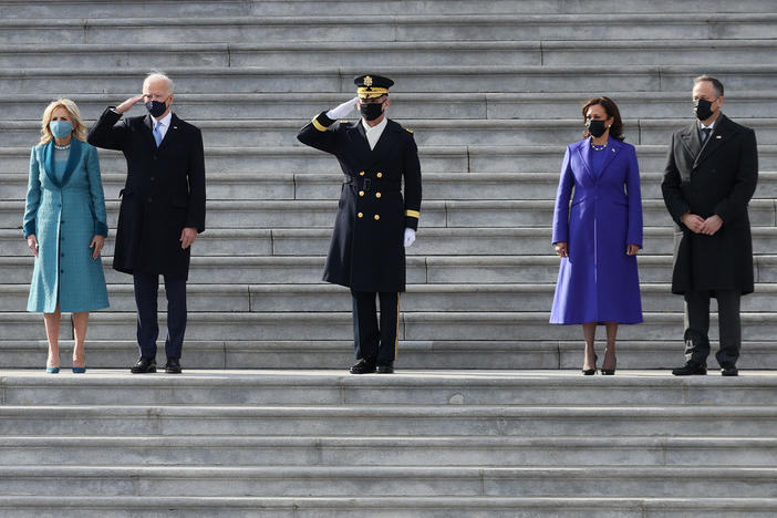 President Biden, first lady Jill Biden, Vice President Harris and second gentleman Doug Emhoff attend a Pass in Review ceremony, hosted by the Joint Task Force-National Capital Region on the East Front of the U.S. Capitol after the inauguration ceremony on Wednesday.