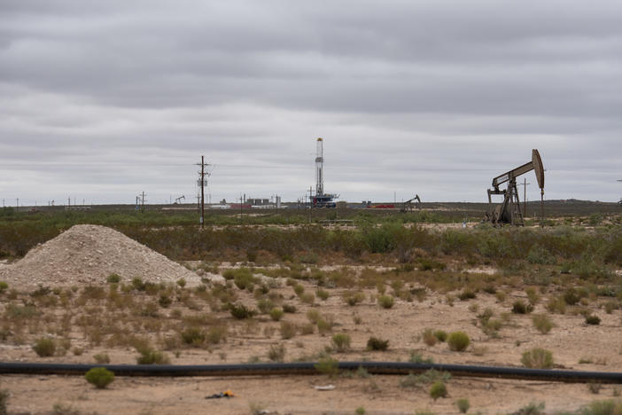 A horizontal drilling rig and a pump jack sit on federal land in Lea County, N.M., in September. The state stands to lose royalties and revenue from a Biden administration pause on new oil and gas leases.