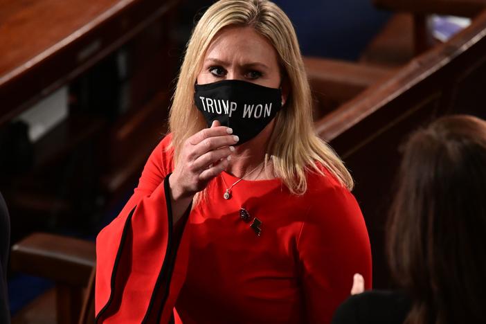 Rep. Marjorie Taylor Greene, R-Ga., wears a "Trump Won" face mask as she arrives on the floor of the House to take her oath of office as a newly elected member of the House of Representatives on Jan. 3.