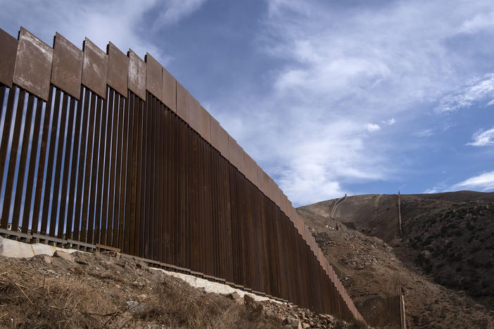 A reinforced section of the U.S.-Mexico border fencing seen in eastern Tijuana, Baja California, Mexico on Jan. 20. President Biden signed an executive action and has halted construction of the massive wall for 60 days.