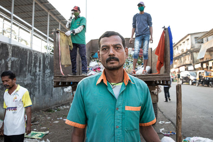 Sanitation worker Ramesh Solanki cleans the streets outside Palghar railway station. "I get up every morning at 5:30, and I see news about the vaccines on TV," he says. "I don't know about any controversies. I just know I'm proud to be part of this."