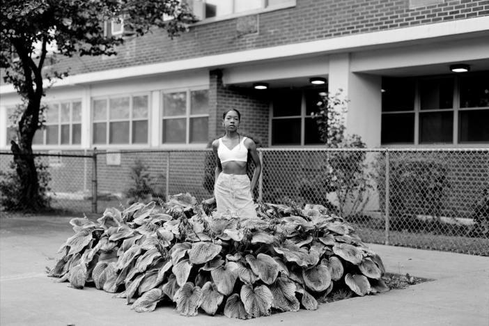 Chanell Stone photographs places like overgrown lots and green spaces at public housing projects, often including herself in the frame. Above, "In search of a certain Eden," 2019, Brooklyn.