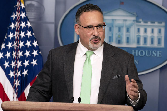 U.S. Education Secretary Miguel Cardona speaks at the White House on Wednesday. The Department of Education says it is scrapping a controversial, Trump-era policy that granted only partial student loan relief to borrowers who were defrauded by private, for-profit colleges.