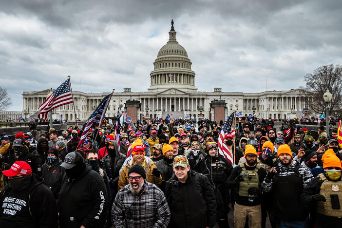 Pro-Trump rioters, including members of the far-right extremist group the Proud Boys, gather near the U.S. Capitol on Jan. 6. At least 25 people charged in the attack appear to have links to the Proud Boys, according to court documents.