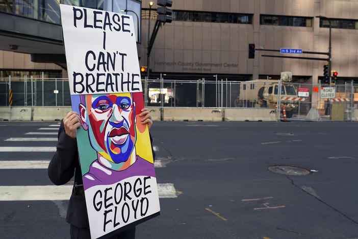 A protester holds a sign across the street from the Hennepin County Government Center in Minneapolis on April 6 during the trial of former police officer Derek Chauvin. The testimony ran for three weeks.