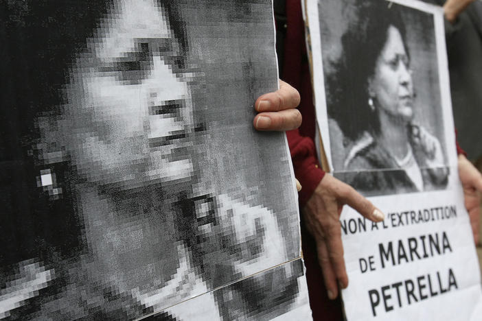 In 2008, people hold portraits of a former member of Italy's disbanded Red Brigades group Marina Petrella as they take part in a rally in Paris against her extradition to Italy. Petrella is one of seven individuals whose arrest in France was announced Wednesday.