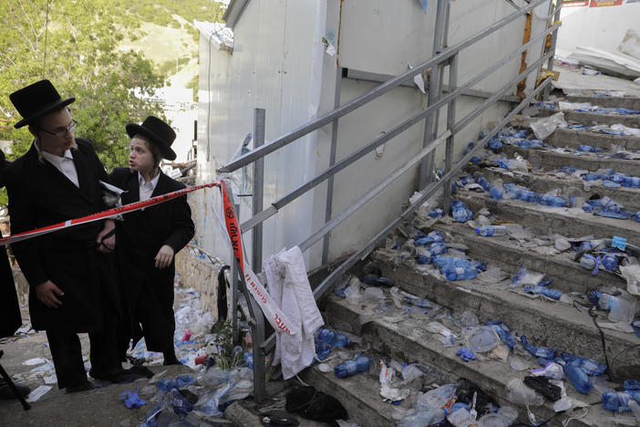 Ultra-Orthodox Jews look at the scene where dozens of people were killed and some 150 injured in a stampede during the Lag BaOmer festival at Mount Meron in northern Israel on Friday.