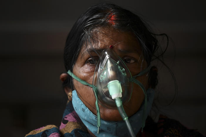 A patient breathes with the help of oxygen provided at a tent installed at a gurdwara, a place of worship for Sikhs, in Ghaziabad, India, on May 2.