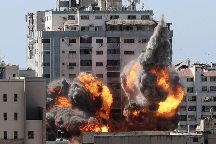 A ball of fire erupts from a building housing various international media, including The Associated Press, after an Israeli airstrike on Saturday in Gaza City. AP staffers and other tenants safely evacuated the building after the Israeli military telephoned a warning that the strike was imminent.