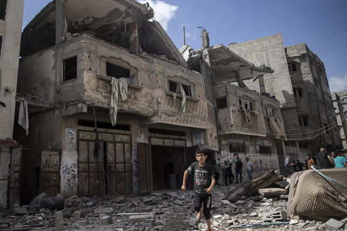 Palestinians inspect damaged houses that were hit early Monday in Israeli airstrikes in Gaza City, Gaza Strip.