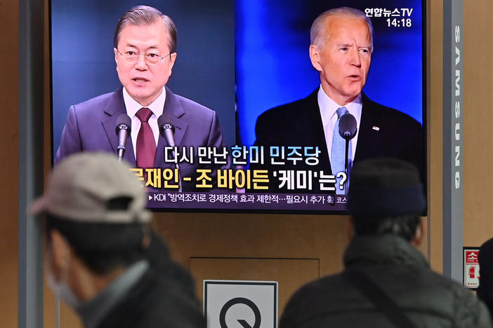 People in Seoul watch a news report in November on the U.S. election, showing images of Joe Biden, newly elected as president, and South Korean President Moon Jae-in.