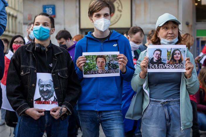 Protesters hold images of Belarus strongman Alexander Lukashenko, Belarus opposition activist Roman Protasevich and Protasevich's partner Sofia Sapega during a demonstration of Belarusians living in Poland and Poles supporting them in front of European Commission office in Warsaw on Monday.