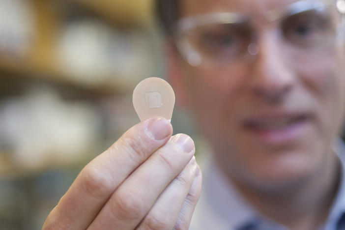 Mark Prausnitz, Georgia Tech Regents' professor in the School of Chemical and Biomolecular Engineering, holds a vaccine patch containing microneedles that dissolve into the skin.
