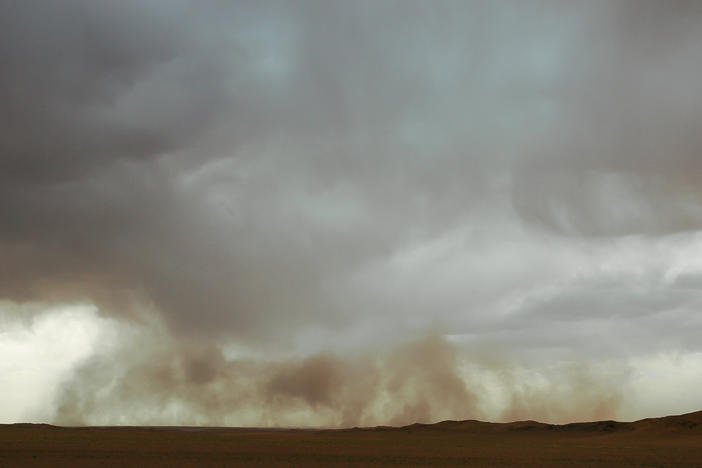 A sandstorm moves the Gobi desert in Mongolia.