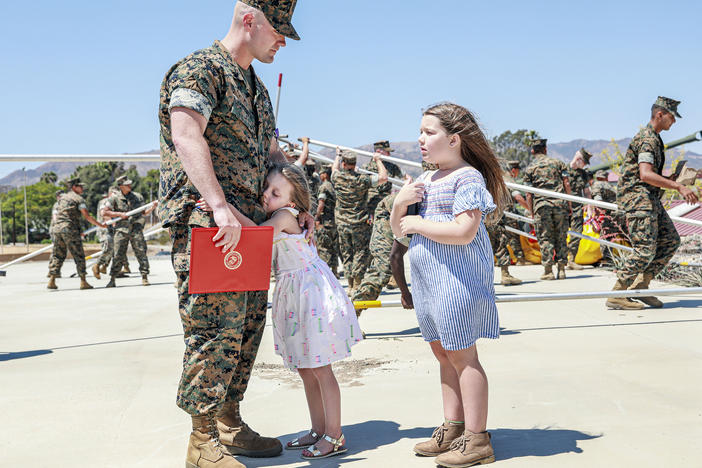 Joseph Hardebeck, a senior Navy corpsman, is greeted by his daughters Zoey, 9, and Adalie, 7, after receiving the Purple Heart at an award ceremony at Southern California's Camp Pendleton on Thursday.