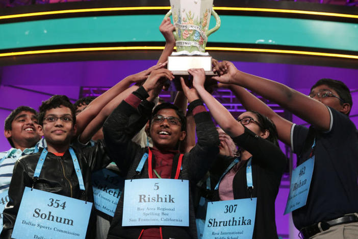 The 2019 Scripps Spelling Bee co-champions hold up their trophy at the Gaylord National Resort & Convention Center in National Harbor, Md. After pausing in 2020, the competition is back on this year. The finals are Thursday night in Orlando, Fla.