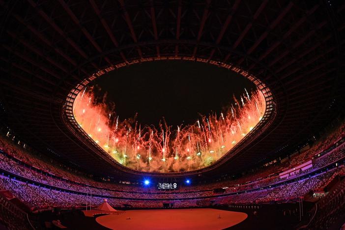 Fireworks go off around the Olympic Stadium during the opening ceremony of the Tokyo 2020 Olympic Games, in Tokyo, on July 23, 2021.