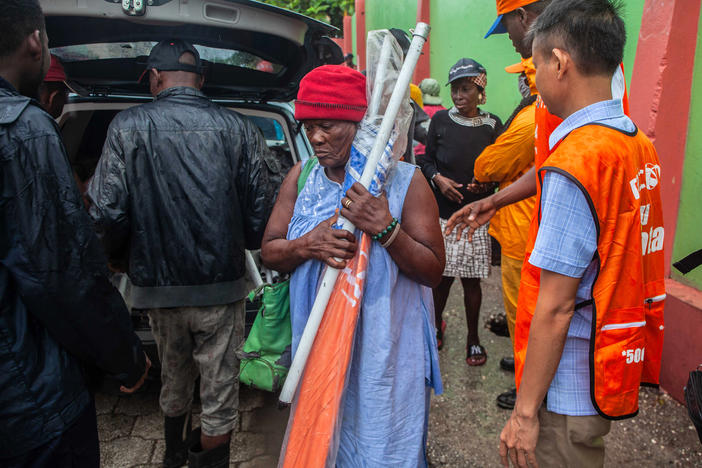 Haitians receive umbrellas as part of humanitarian aid after a 7.2 magnitude earthquake struck Haiti on Aug. 14.