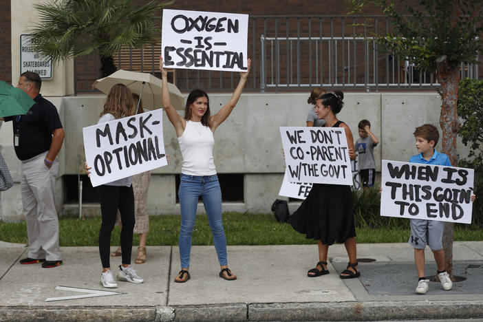 Families protest any potential mask mandates before the Hillsborough County School Board meeting last month in Tampa, Fla.