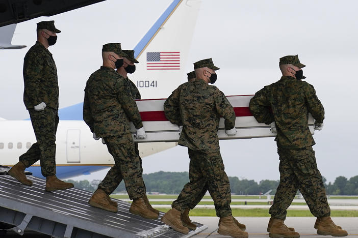 A carry team moves a transfer case containing the remains of Marine Corps Lance Cpl. Jared M. Schmitz during a casualty return on Sunday at Dover Air Force Base, Del.