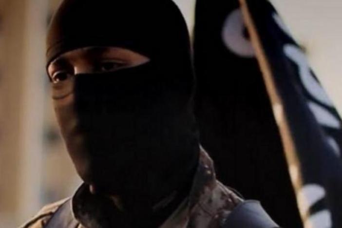 A photo provided by the FBI depicts a masked militant from an ISIS propaganda video from 2014. The individual pictured has allegedly been identified as Mohammed Khalifa.