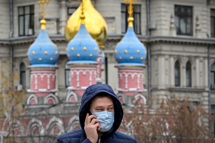 A man wearing a face mask speaks on his phone in central Moscow on Wednesday.