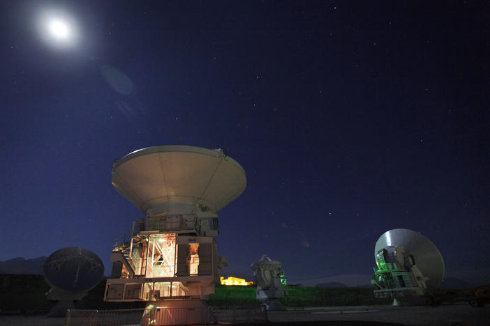 The moon shines over radio antennas at the operations support facility of one of the worlds largest astronomy projects, the Atacama Large Millimeter/submillimeter Array (ALMA), in the Atacama desert in northern Chile in this 2012 photo.