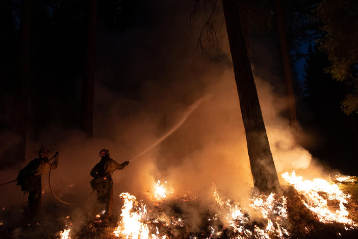 Fire crews manage a back fire in Sly Park, Calif., fighting the Caldor Fire on Aug. 23. <a href="https://www.capradio.org/articles/2021/08/25/photos-caldor-fire-leaves-destroyed-homes-difficult-firefight-in-el-dorado-county/">Full Story</a>