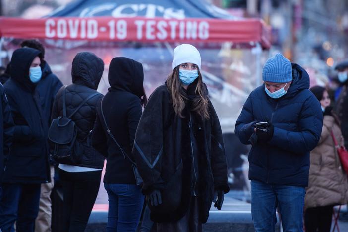 People wait at a street-side testing booth in New York's Times Square on Monday.
