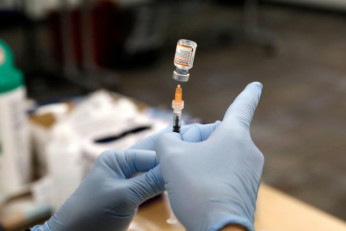 A nurse practitioner fills a syringe with the Pfizer COVID-19 vaccine at the Beaumont Health offices in Southfield, Mich., on Nov. 5.